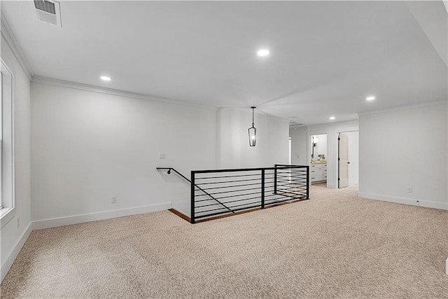 basement with ornamental molding and light colored carpet