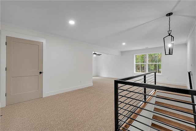 hallway with crown molding and carpet floors