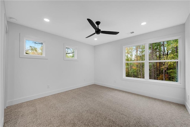 unfurnished room featuring ceiling fan, a healthy amount of sunlight, and carpet floors