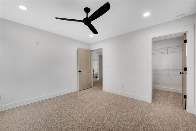 unfurnished bedroom featuring a closet, light carpet, and ceiling fan