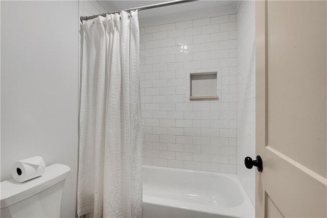 bathroom with toilet and shower / bath combo with shower curtain