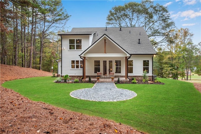 rear view of house with a yard and french doors