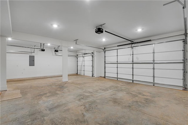 garage with a garage door opener and electric panel