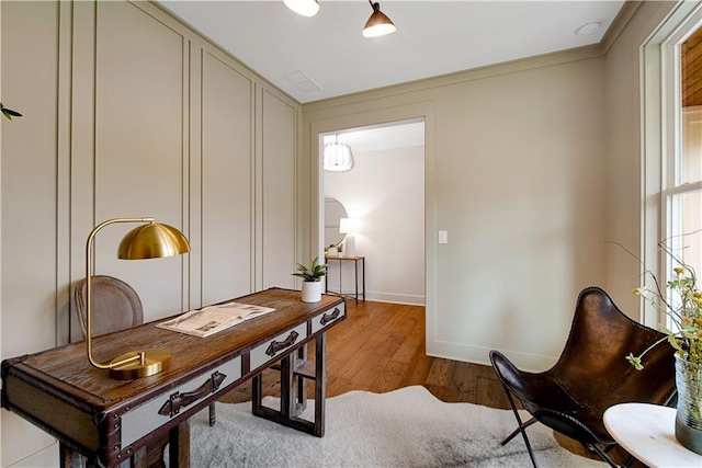 office space featuring hardwood / wood-style flooring and crown molding