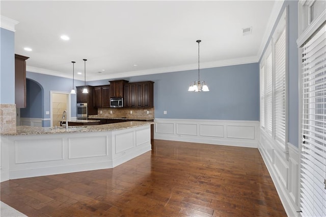 kitchen with visible vents, dark brown cabinetry, appliances with stainless steel finishes, and dark wood finished floors