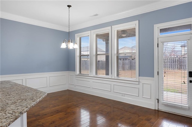 unfurnished dining area with visible vents, a healthy amount of sunlight, and dark wood-type flooring