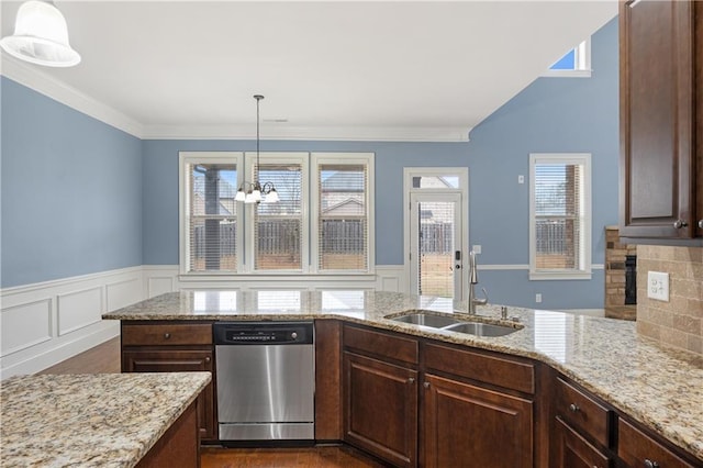 kitchen with light stone counters, a fireplace, a sink, dark brown cabinetry, and dishwasher