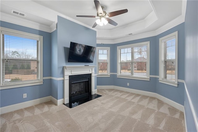 unfurnished living room with visible vents, a fireplace with flush hearth, baseboards, and carpet