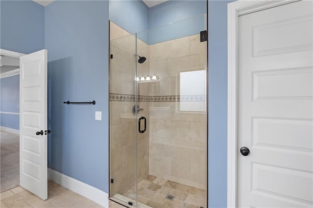 full bathroom featuring tile patterned floors, a stall shower, and baseboards