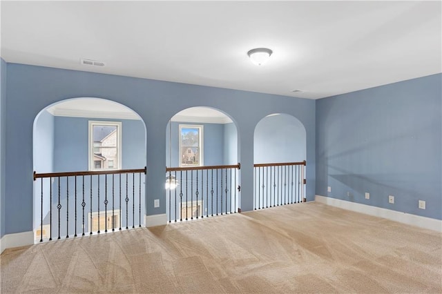 empty room with visible vents, baseboards, and carpet floors