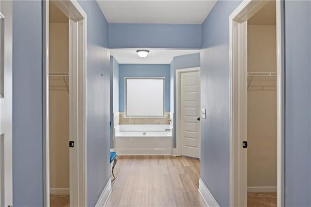 hallway with light wood-style floors