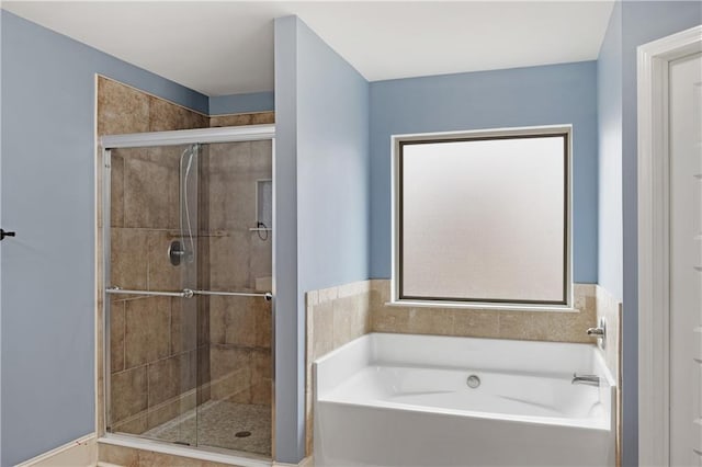 bathroom featuring a garden tub and a stall shower