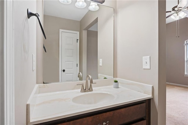 bathroom featuring vanity, baseboards, and ceiling fan