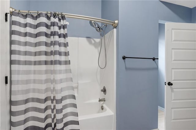 bathroom featuring shower / bathtub combination with curtain