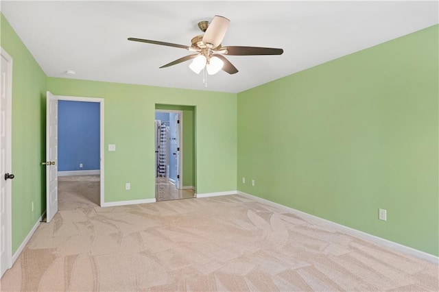 unfurnished bedroom featuring baseboards, carpet floors, and ceiling fan