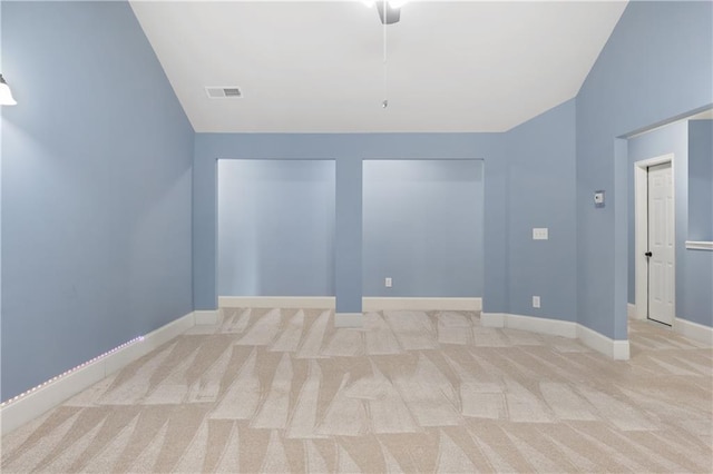 carpeted empty room with visible vents and baseboards