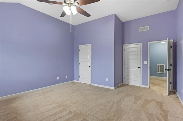 unfurnished bedroom with visible vents, light colored carpet, and baseboards