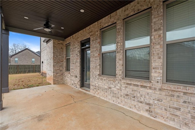 view of patio with a ceiling fan and fence