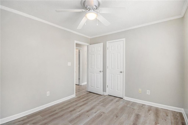 unfurnished bedroom with baseboards, ornamental molding, a ceiling fan, and wood finished floors
