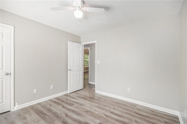 unfurnished bedroom with a textured ceiling and wood finished floors