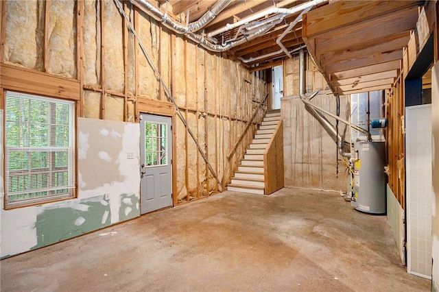 basement featuring gas water heater and stairway