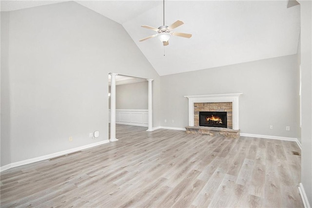 unfurnished living room with a ceiling fan, high vaulted ceiling, light wood-type flooring, and a fireplace