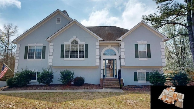 bi-level home with stucco siding