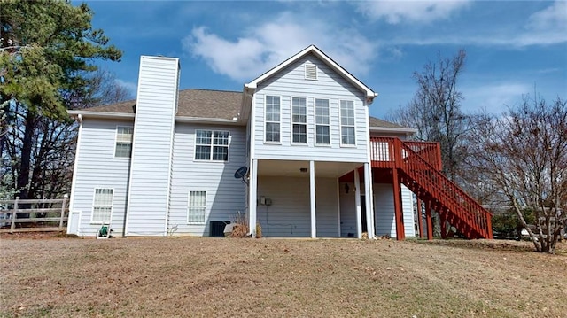 back of house with a lawn, stairs, fence, a wooden deck, and a chimney