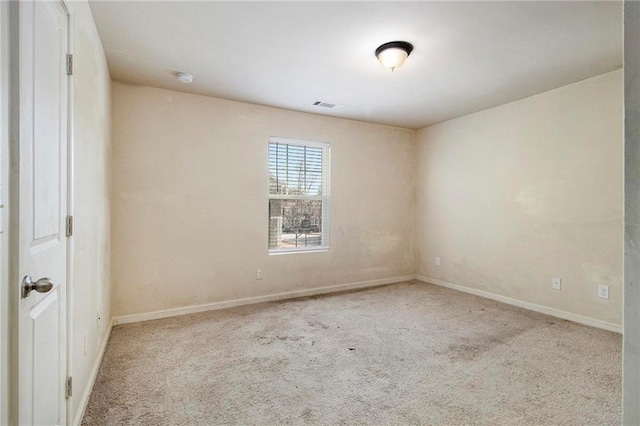 unfurnished room featuring light carpet