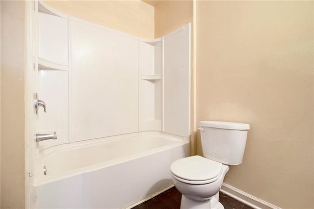 bathroom with toilet and bathing tub / shower combination