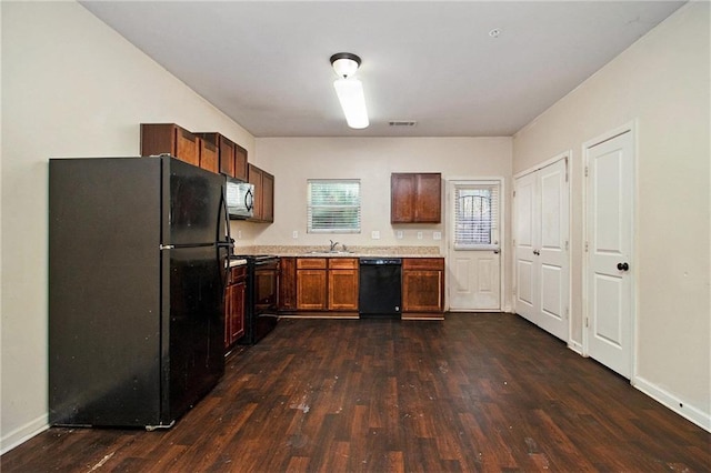 kitchen featuring sink, black appliances, and dark hardwood / wood-style floors