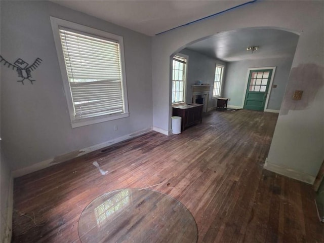 1437 Troupe St, Augusta, GA 30904 - unfurnished living room featuring arched walkways, wood finished floors, and a fireplace