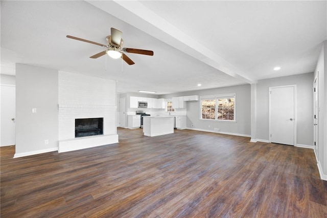 unfurnished living room featuring a brick fireplace, dark wood-type flooring, and ceiling fan