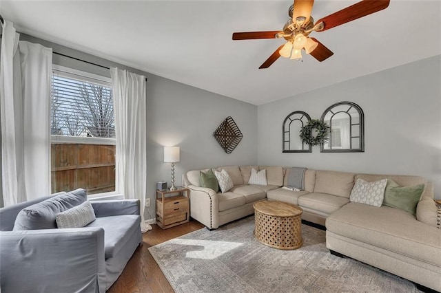 living room with a ceiling fan and dark wood-style flooring