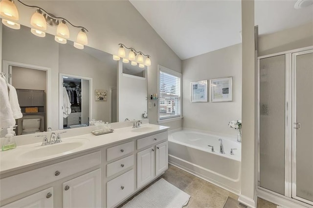 full bathroom featuring double vanity, a stall shower, lofted ceiling, a sink, and a bath