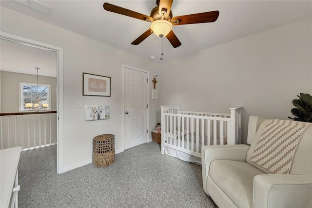 bedroom with ceiling fan with notable chandelier, carpet floors, and baseboards