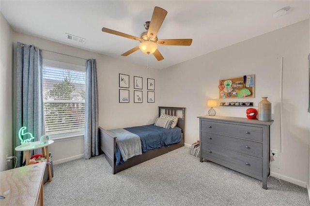 bedroom featuring a ceiling fan, light colored carpet, visible vents, and baseboards