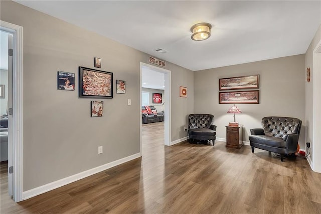 living area with wood finished floors and baseboards