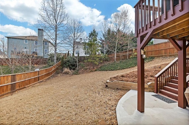 view of yard with a patio area, a fenced backyard, and stairway