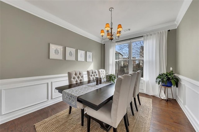 dining space with visible vents, ornamental molding, dark wood finished floors, and a notable chandelier