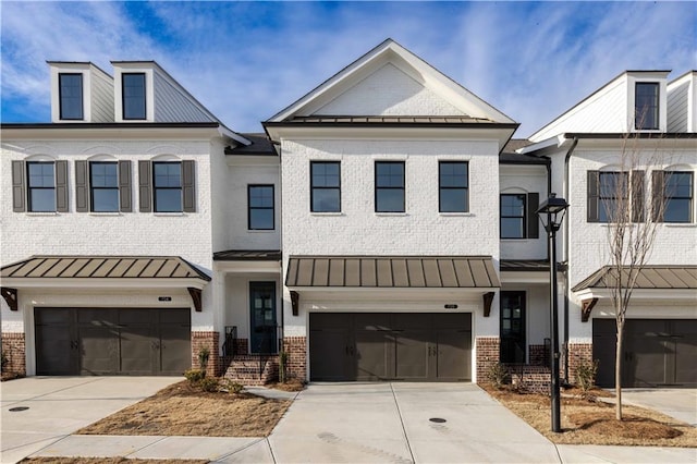 706 Dodd Ln Unit 157, Buford, GA 30518 - multi unit property featuring a standing seam roof, brick siding, and a garage