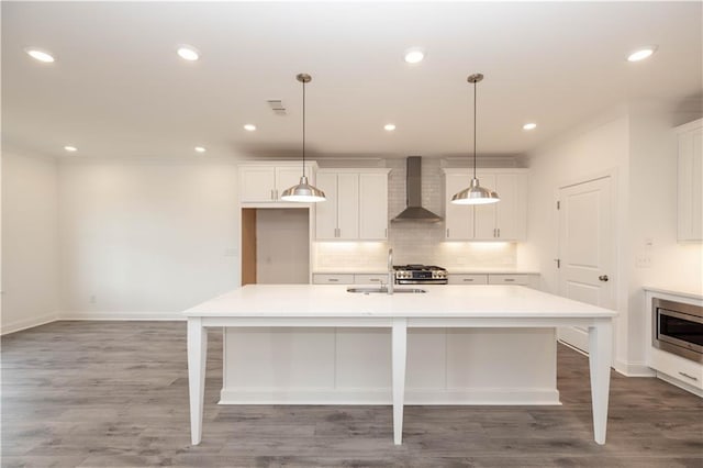 706 Dodd Ln Unit 157, Buford, GA 30518 - kitchen with wall chimney range hood, stainless steel appliances, a sink, white cabinetry, and backsplash