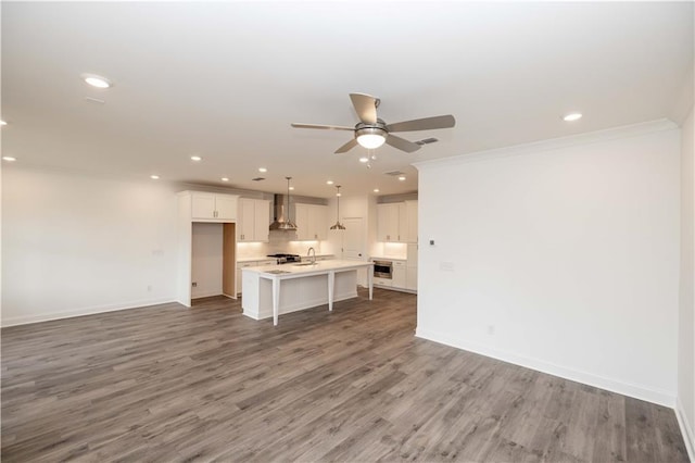 706 Dodd Ln Unit 157, Buford, GA 30518 - unfurnished living room with a ceiling fan, recessed lighting, baseboards, light wood-type flooring, and crown molding