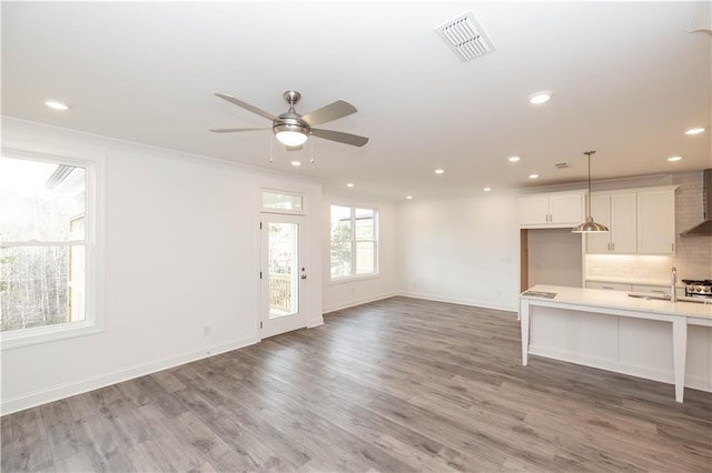 706 Dodd Ln Unit 157, Buford, GA 30518 - unfurnished living room featuring recessed lighting, a ceiling fan, light wood finished floors, baseboards, and a sink