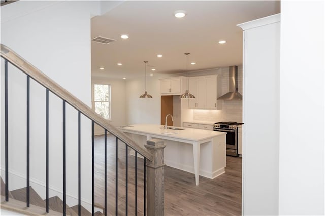 706 Dodd Ln Unit 157, Buford, GA 30518 - kitchen with gas stove, wall chimney exhaust hood, a sink, recessed lighting, and tasteful backsplash