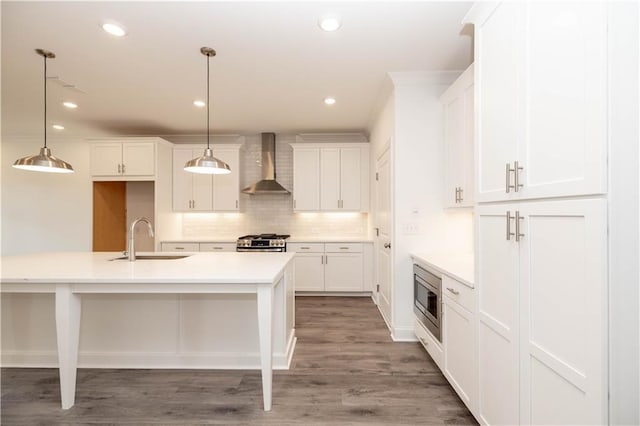 706 Dodd Ln Unit 157, Buford, GA 30518 - kitchen with wall chimney range hood, a sink, stainless steel appliances, decorative backsplash, and light countertops