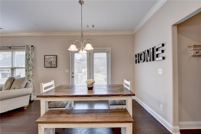 dining area featuring a wealth of natural light, ornamental molding, a notable chandelier, and dark hardwood / wood-style floors