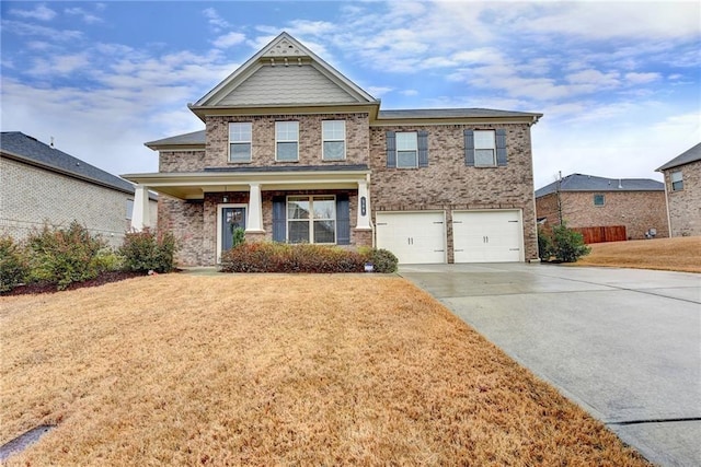 craftsman-style home featuring a front yard and a garage