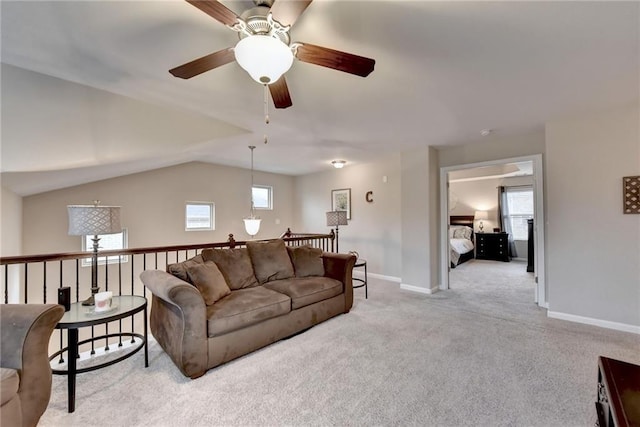 living room featuring ceiling fan, lofted ceiling, and light colored carpet