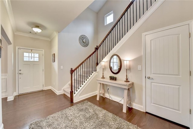 entryway with crown molding and dark hardwood / wood-style floors